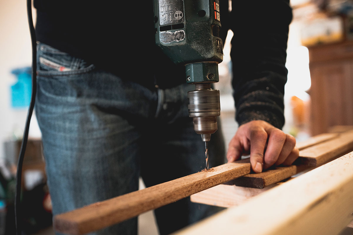 Man drilling wood 1 Man drilling wood 1